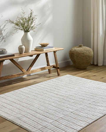 Entryway with a Cascade White Area Rug, wooden bench, vases, books, and woven basket. Farmhouse style. Roomscene-Rectangle