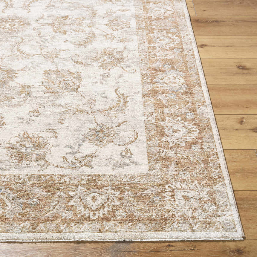 Close-up of the Tylie Blue Area Rug showing its traditional floral pattern and cream, tan, and light brown colors. Front