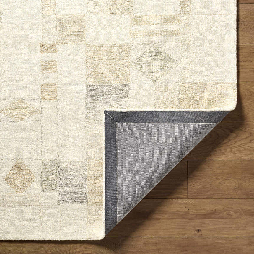 Close-up of the hand-tufted Tovah Area Rug. Ash and light silver wool rug with a contemporary geometric pattern. Fold