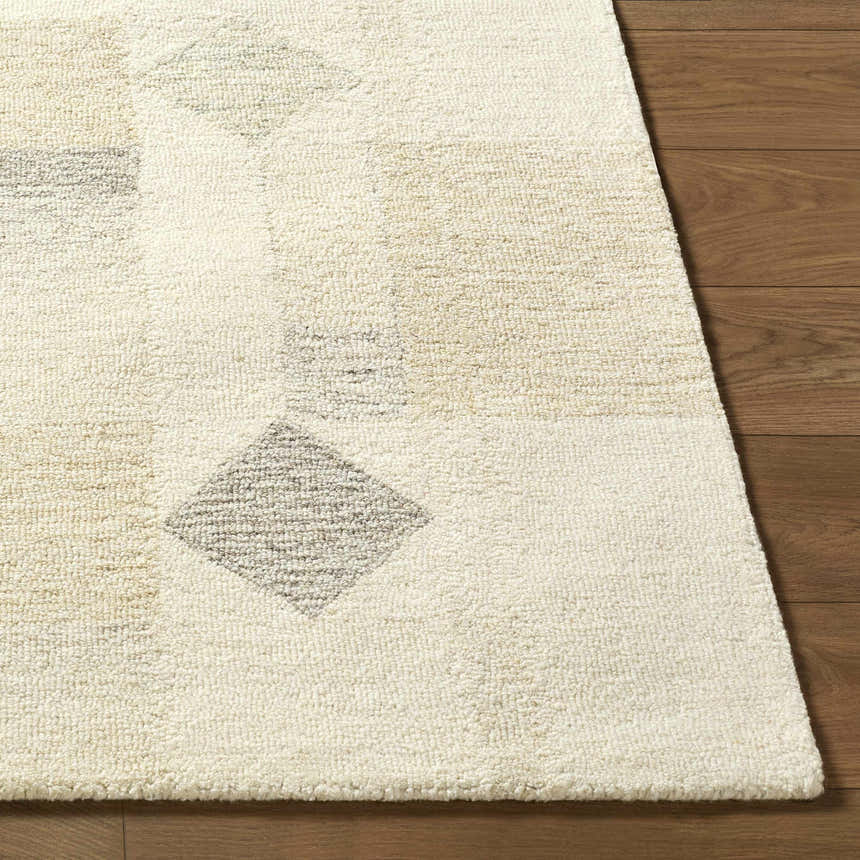 Close-up of the hand-tufted Tovah Area Rug. Ash and light silver wool with a geometric diamond pattern. Contemporary style. Front