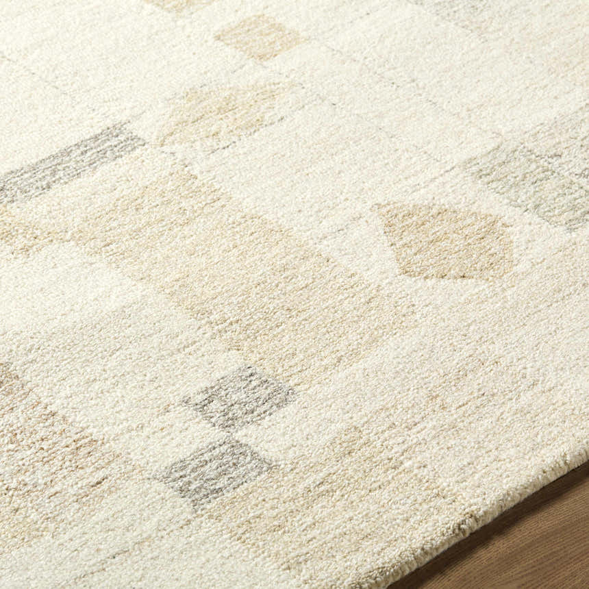 Close-up of the hand-tufted Tovah Area Rug. Ash and light silver wool rug with a contemporary geometric pattern. Texture