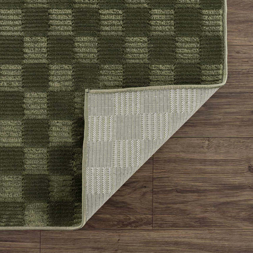 Close up of the green Truls 3D Checkered Washable Rug showing the textured checkered design and rug backing. Fold