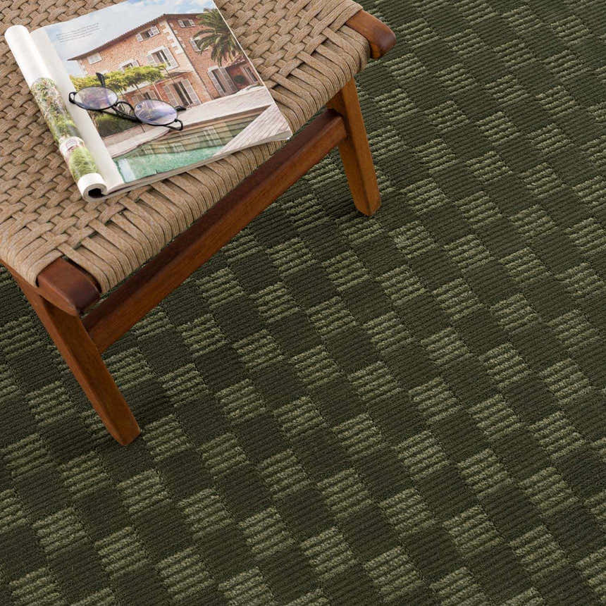 Close-up of the green Truls 3D Checkered Washable Rug, showing its textured checkered pattern and rich color. Styleshot