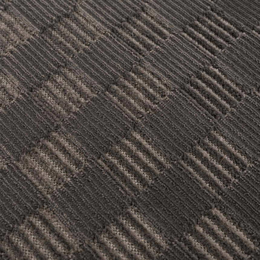 Close-up of the Truls 3D Checkered Washable Rug. Black and gray textured rug with a raised checkered pattern. Texture