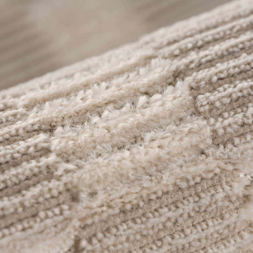 Close-up of the Biscotti Truls 3D Checkered Washable Rug, showing its beige and cream checkered pattern and soft, textured pile. Fold