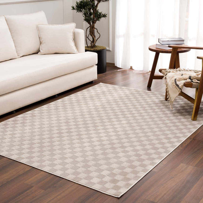 Living room scene with a biscotti Truls 3D Checkered Washable Rug, cream sofa, wood chair, and light neutral decor. Roomscene-Rectangle