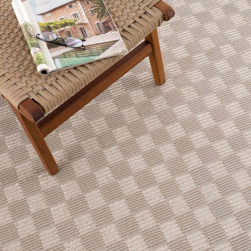 Close-up of the Truls 3D Checkered Washable Rug in Biscotti, showing beige and cream checkered pattern and textured weave. Styleshot