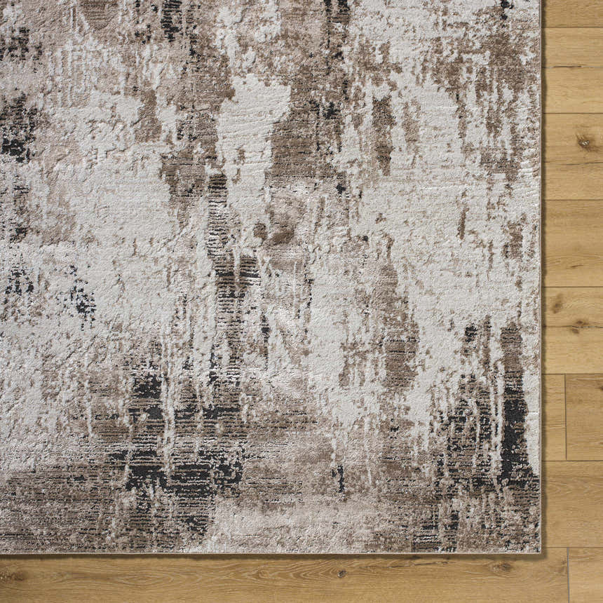 Close up of the Taszi Luxe Thick Area Rug. Contemporary design in ivory, tan, and black on wood floor. Corner