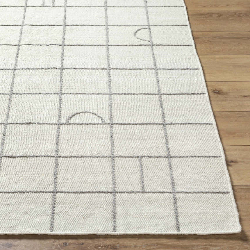Close-up of Tieve Black & White Grid Wool Rug showing cream color and gray grid pattern on wood floor. Front