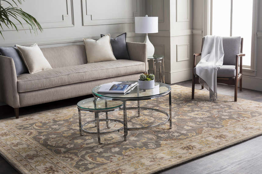 Living room with a Cherryfield Hand Tufted Taupe Wool Rug, sofa, glass tables, and chair with throw. Neutral tones. Roomscene-Rectangle