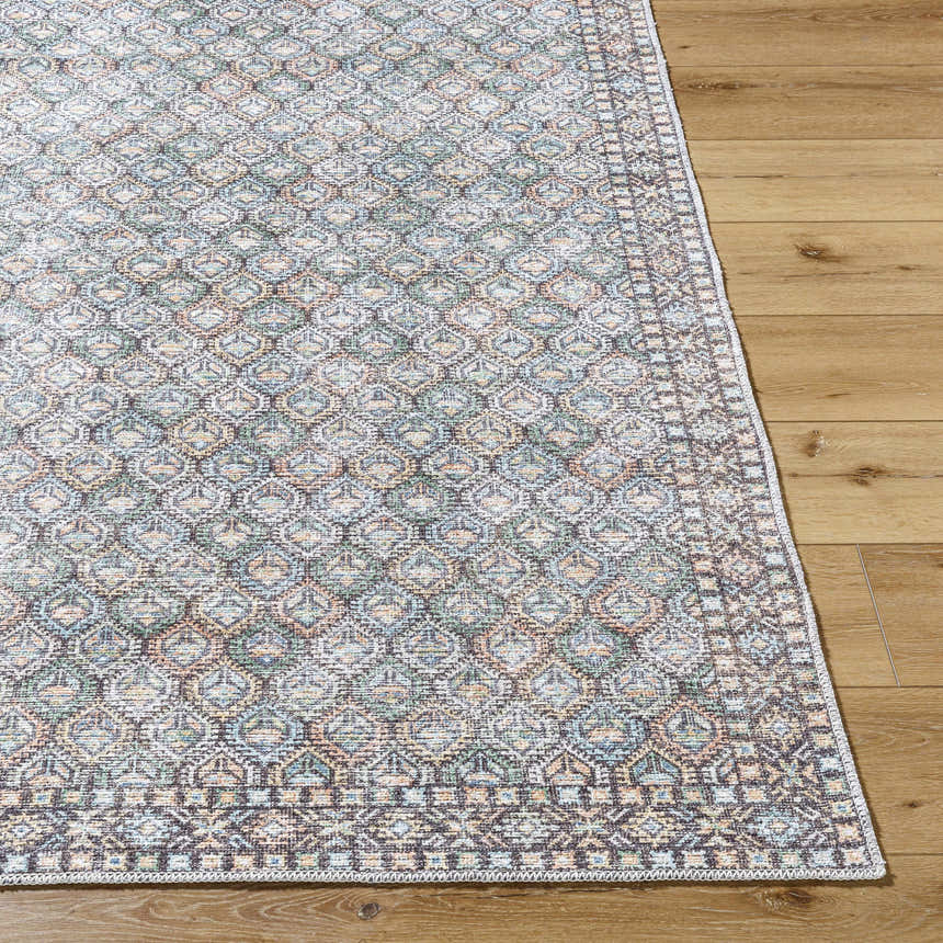 Close-up of the Telma Medium Green Washable Area Rug, showcasing its traditional pattern and colors of green, blue, and cream. Front