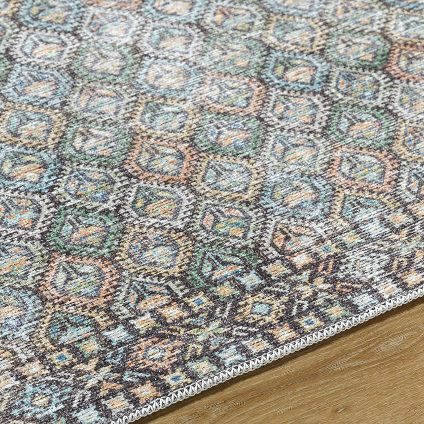 Close-up of the Telma Medium Green Washable Area Rug. Features a traditional pattern in green, blue, cream, and mustard. Texture
