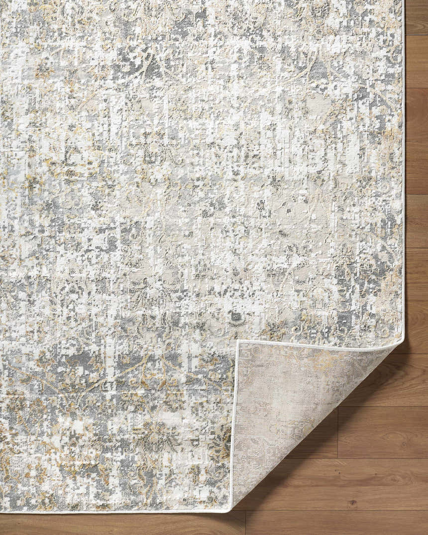 Close-up of the Tiago Area Rug showing its beige, charcoal, cream, and gray contemporary design and texture. Fold