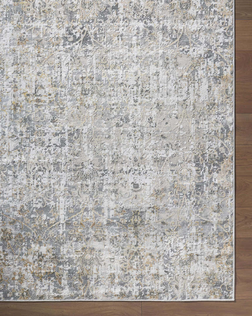 Close-up of the Tiago Area Rug showing its beige, charcoal, and gray contemporary pattern and machine-woven texture. Corner