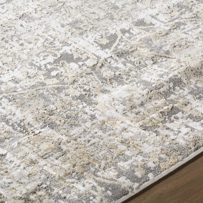Close-up of the Tiago Area Rug showing its beige, charcoal, cream, and gray contemporary design and machine woven texture. Texture