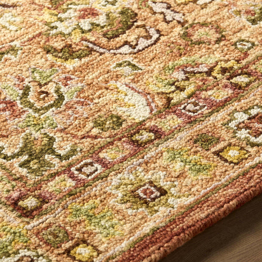 Close-up of the hand-tufted Annick Area Rug, a farmhouse style rug in wool with a traditional floral pattern. Texture