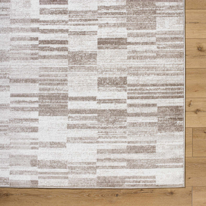 Close-up of Tehya Beige Area Rug featuring a contemporary light silver and silver gray block pattern. Corner