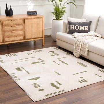 Living room scene with Azriel Green Washable Area Rug, white sofa, wooden cabinet, and potted plant. Contemporary style. Roomscene-Rectangle