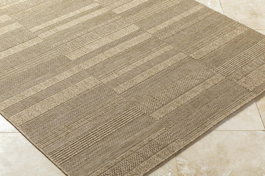Close-up of the Thana Brown Area Rug showing its camel, tan, and prairie dust woven texture and rectangular shape. Corner