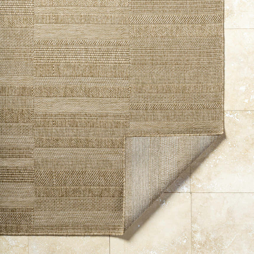 Close-up of the Thana Brown Area Rug showing its camel, tan, and prairie dust color and woven texture. Fold