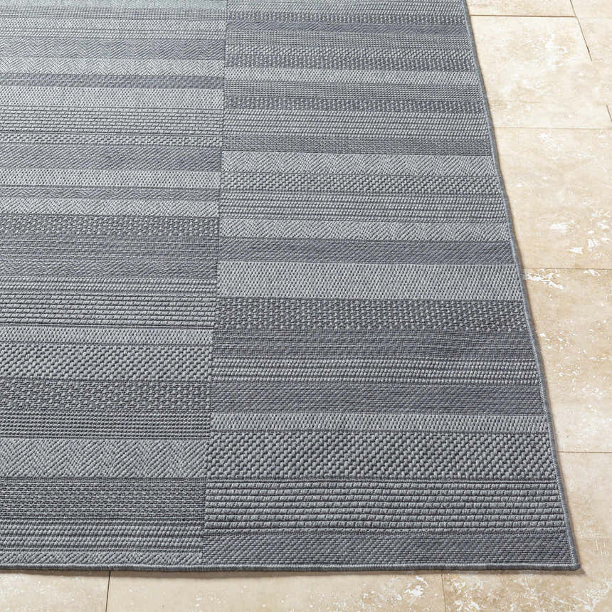 Close-up of the Thana Gray Area Rug showing its charcoal and gray striped pattern and woven texture. Front