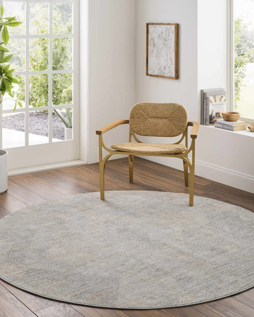 Light-filled room with round Urmi Thick Luxe Area Rug, woven chair, and wood floors. Contemporary style. Roomscene-Round