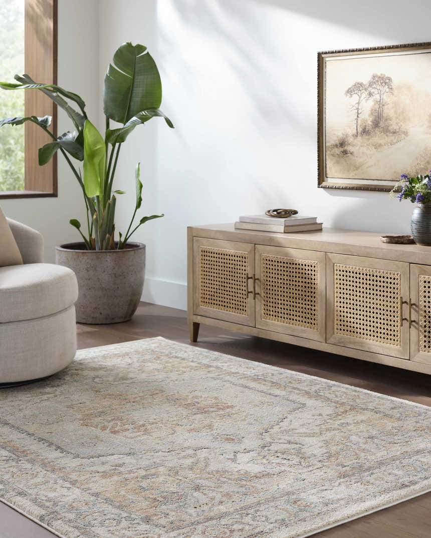 Living room scene with beige swivel chair and Vaeda Blue & Beige rug. Farmhouse style with light wood cabinet and large plant. Roomscene-Rectangle