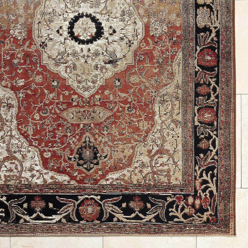 Close-up of the Vonda Area Rug, showcasing its crimson, ivory, and charcoal traditional floral pattern and black border. Corner