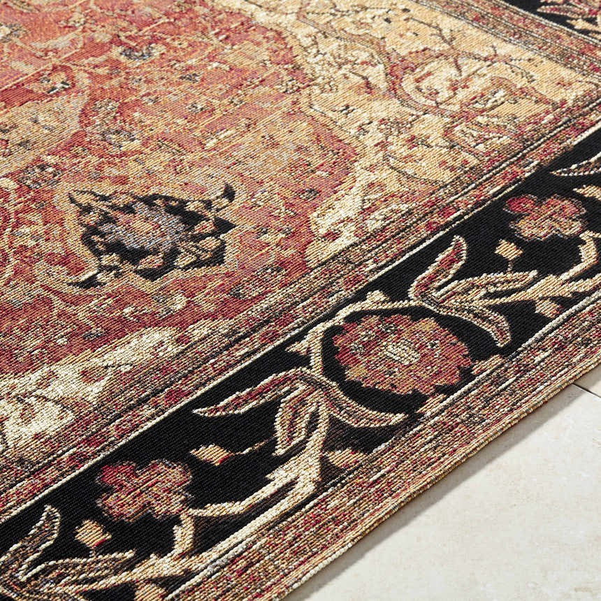 Close-up of the Vonda Area Rug. Traditional design in charcoal, crimson, gold, and ivory. Machine woven texture. Texture