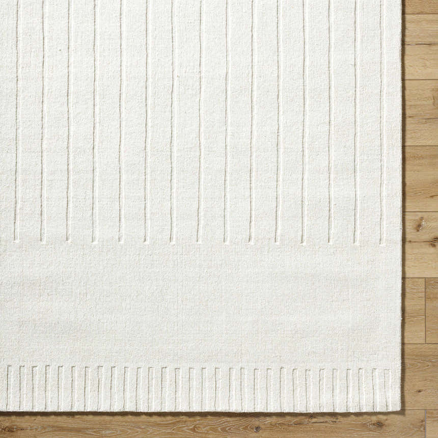 Close up of the hand-loomed Arnona Off White Area Rug showing its vertical stripe design and wool texture. Corner