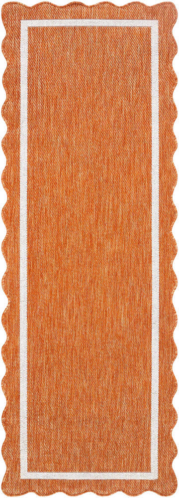 Close-up of the Varro Rust Area Rug. Features a cream border and a unique wavy edge. The rug is rust-colored. Design-Runner-2773
