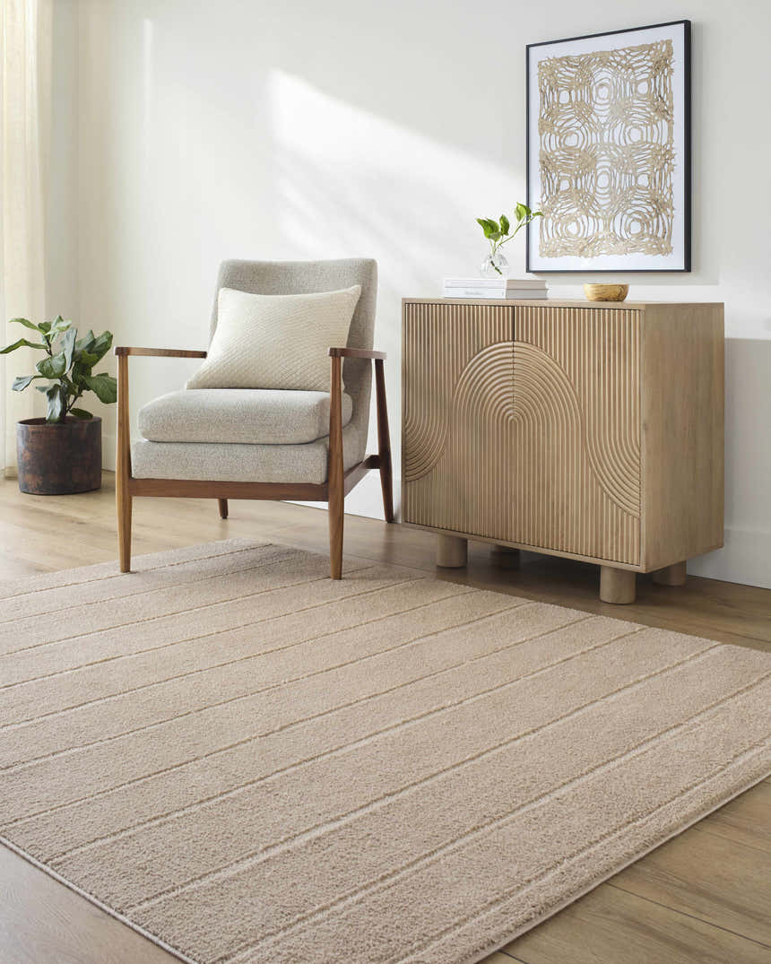 Living room scene with a Cascade Brown Area Rug, gray chair, and light wood cabinet. Roomscene-Rectangle