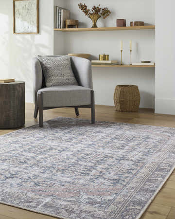 Living room scene with gray chair and Valar Washable Area Rug in beige, blue, and dark red traditional pattern. Roomscene-Rectangle