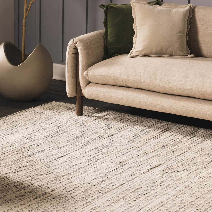 Living room scene with a cream couch and the cream and black Williford Wool Area Rug. Styleshot