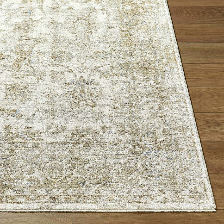 Close up of the Arella Area Rug in ivory, sandstone, slate gray, and taupe on hardwood flooring. Front