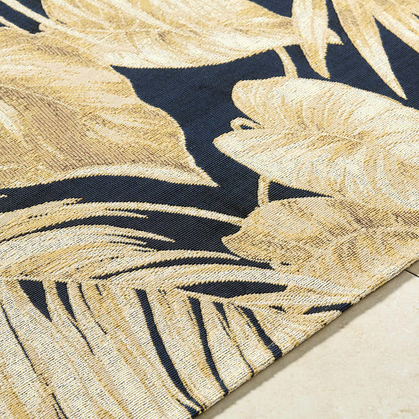 Close-up of the Amirah Midnight Blue Area Rug showing its goldenrod palm leaf pattern and machine-woven texture. Texture