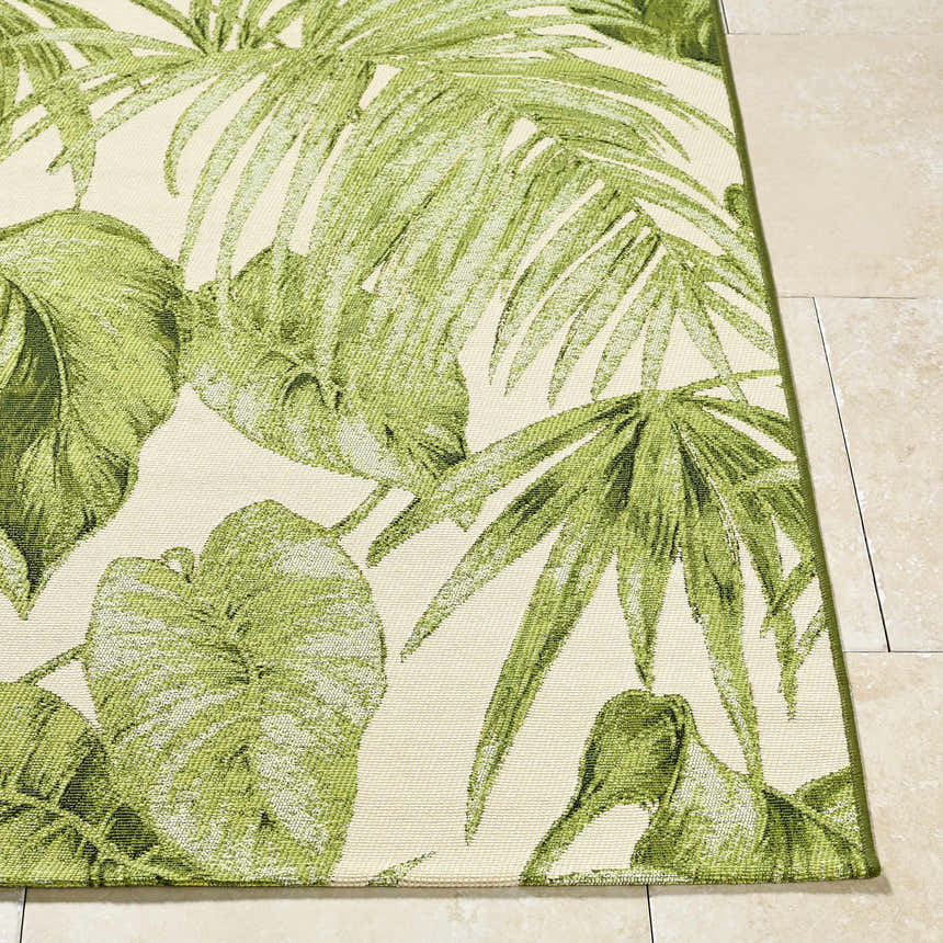 Close up of the Amirah Green Area Rug showing the ivory and olive tropical leaf pattern. Front