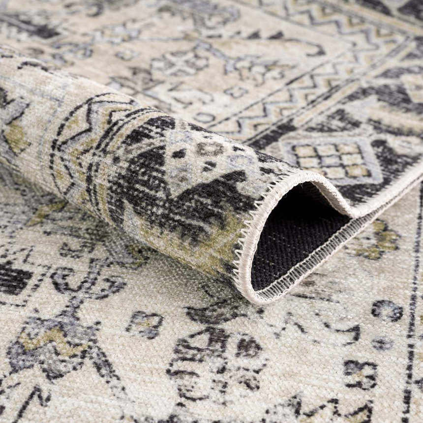 Close-up of the Holi-4606 Washable Area Rug showing its black, gold, and beige traditional vintage pattern and texture. Fold