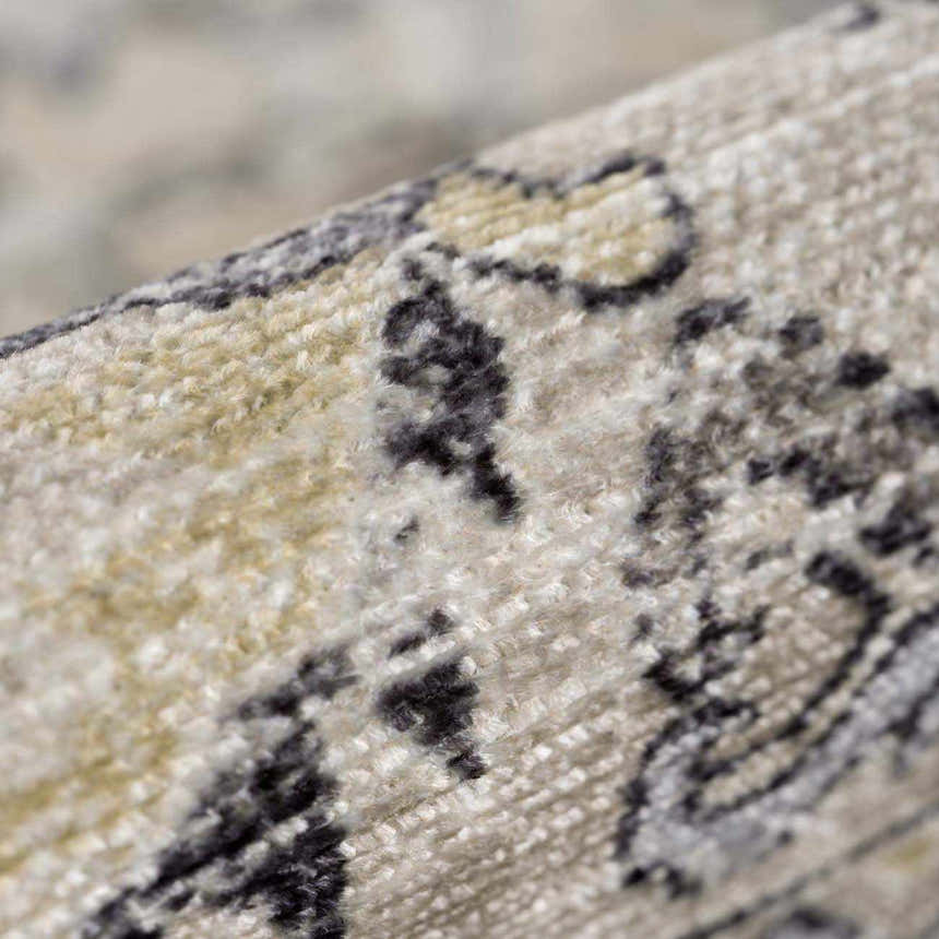 Close-up of the Holi-4606 Washable Area Rug showing its traditional vintage pattern in black and gold on a textured surface. Fold