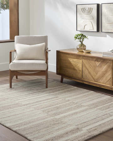 Living room scene with ash and sage Xanti Area Rug, neutral armchair, and wood console table. Contemporary style. Roomscene-Rectangle