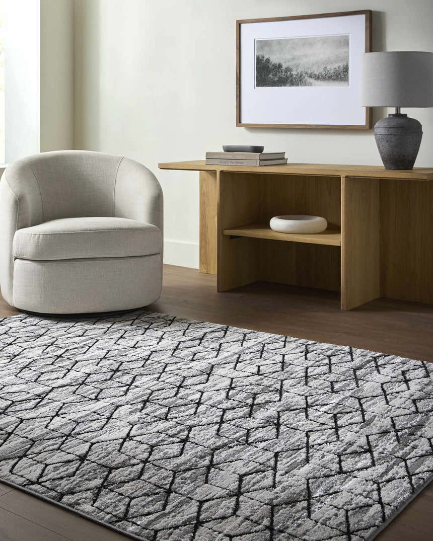 Contemporary living room with gray swivel chair and black geometric Yaqub Area Rug. Roomscene-Rectangle