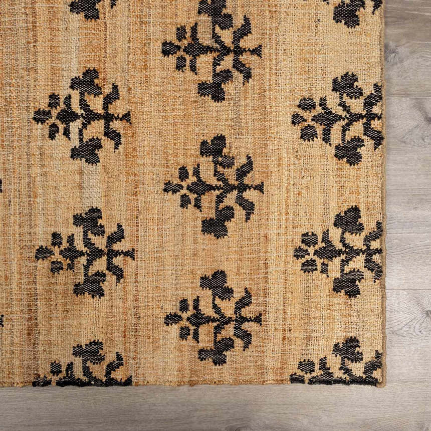 Close-up of Albina Florentine Jute&Wool Rug. Tan jute rug with a black floral-like pattern. Hand woven texture. Swatch