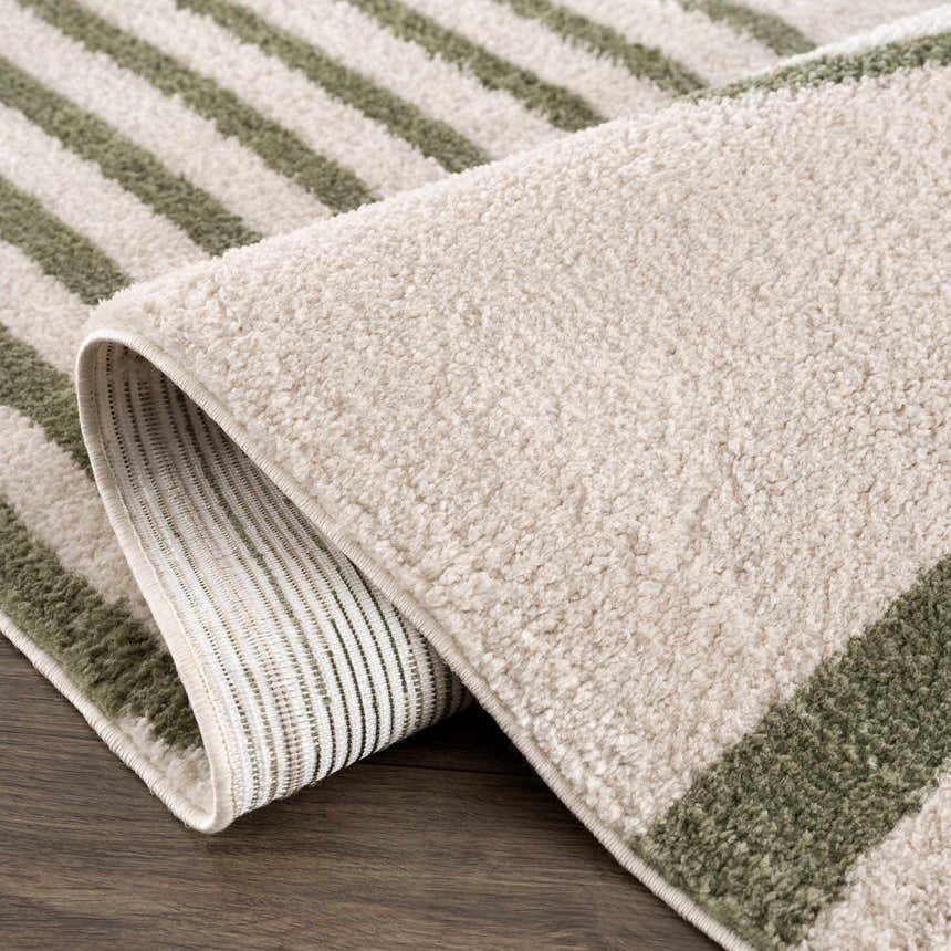 Close-up of the lime green striped Yasuo Green Washable Area Rug showing texture and backing. Fold