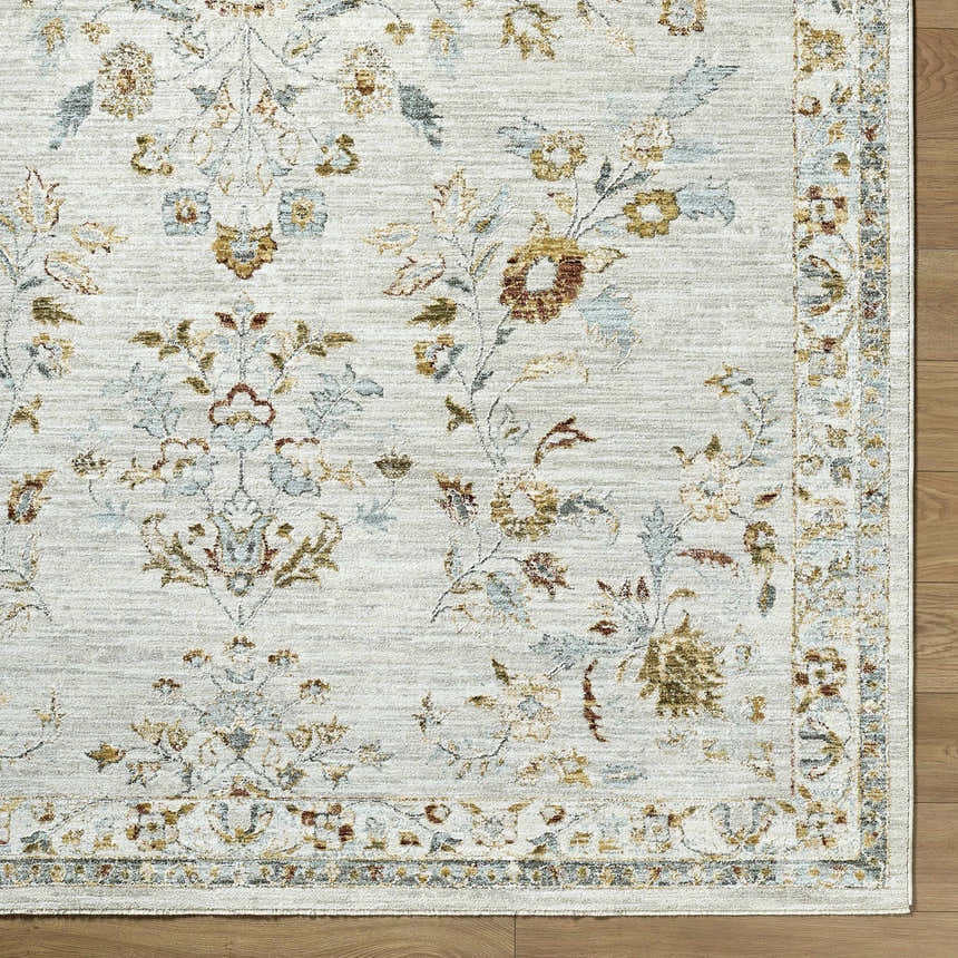 Close up of the Yazid Area Rug. Cream rug with floral pattern in ivory, light gray, mustard, pale blue, and sage. Front