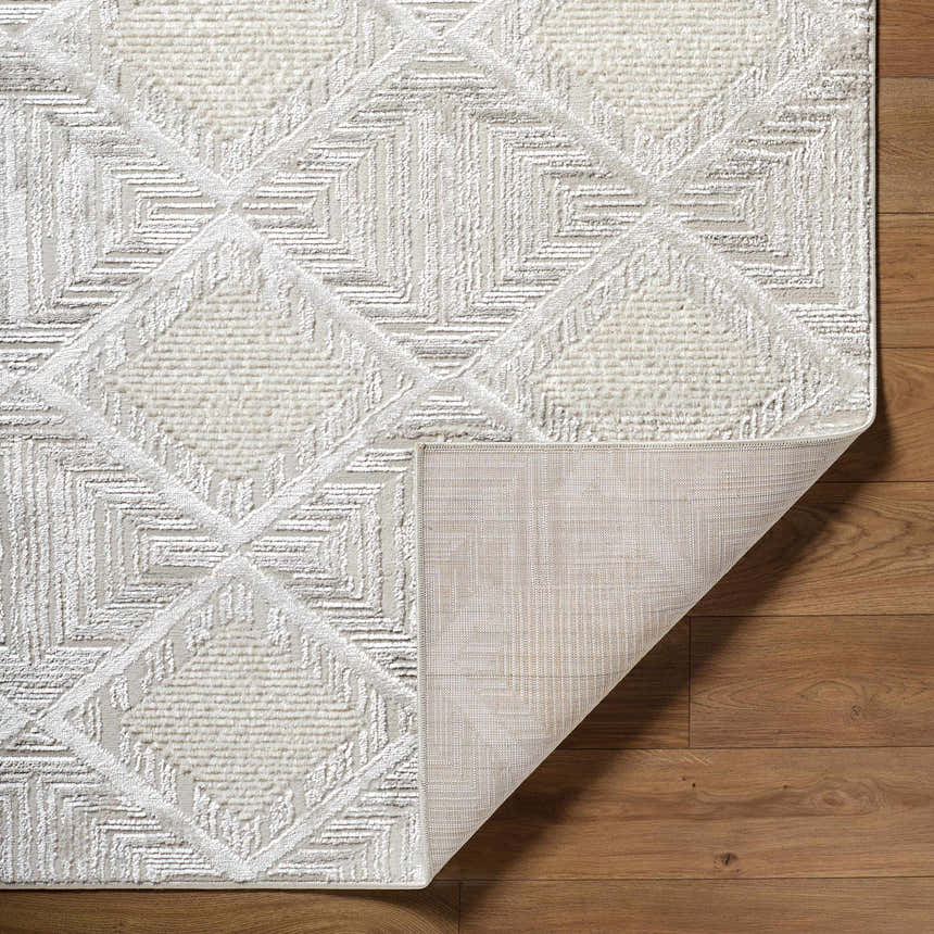 Close-up of the Yayoi Area Rug, a cream and gray contemporary rug with a geometric diamond pattern and textured weave. Fold