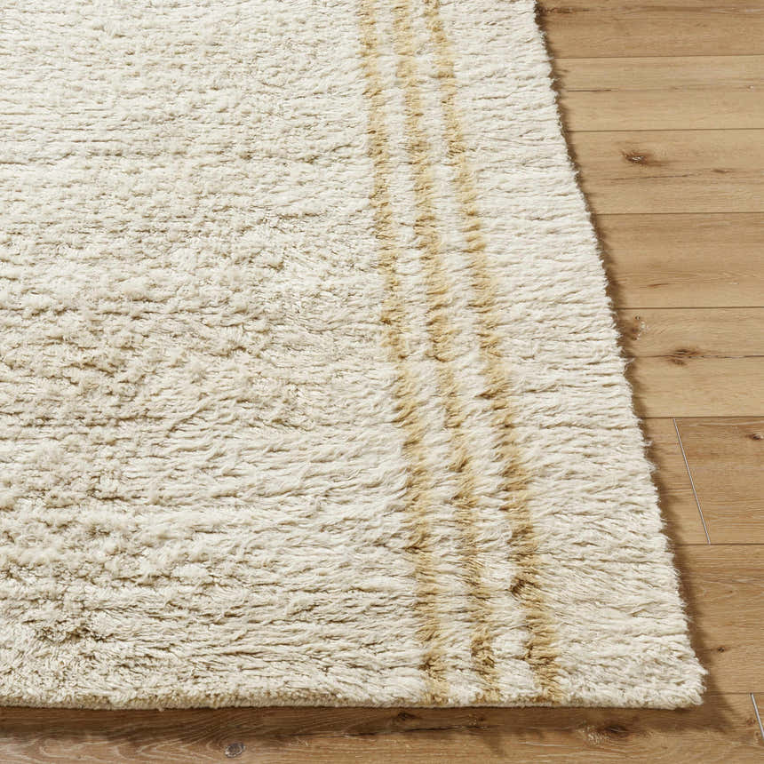 Close-up of the hand-tufted Yahto Area Rug. Camel and tan wool rug with a textured, farmhouse style design. Front