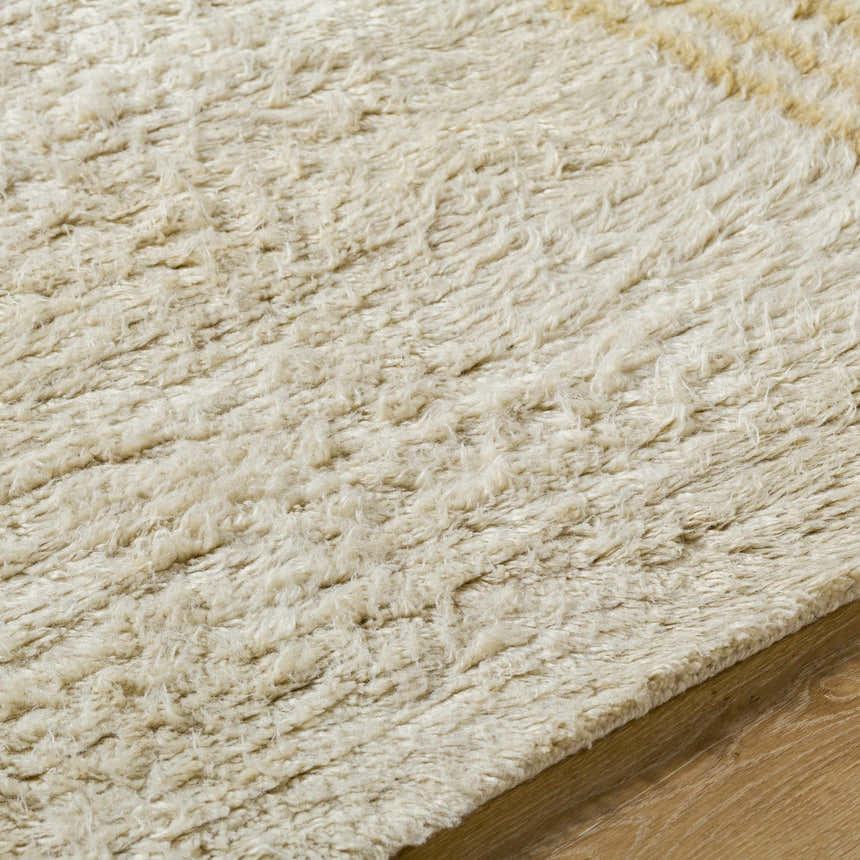 Close-up of the hand-tufted Yahto Area Rug. Camel, desert tan, and pearl wool fibers create a soft, textured farmhouse rug. Texture