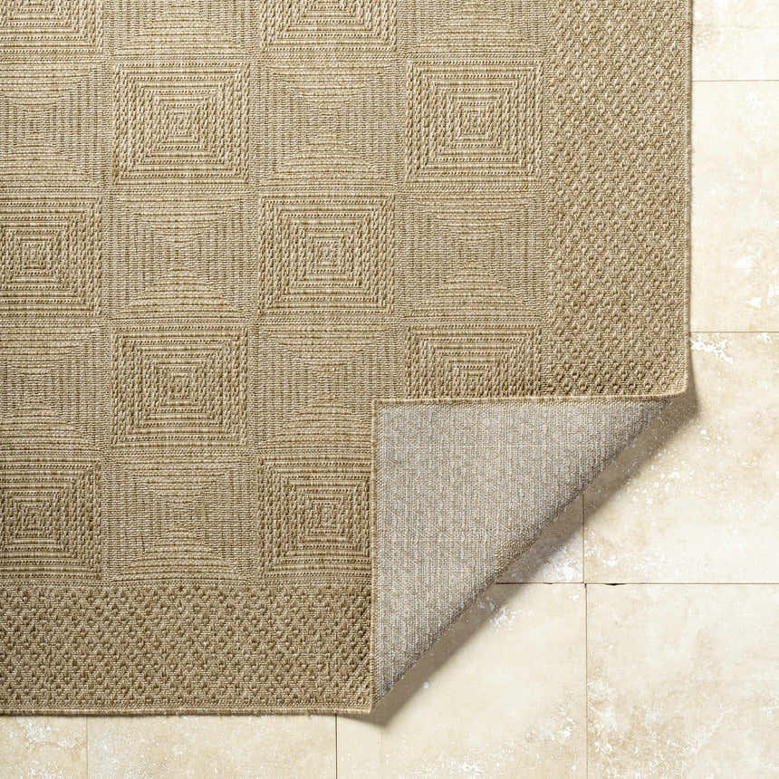 Close-up of Anabia Brown Area Rug showing geometric square pattern and woven texture in prairie dust and tan colors. Fold