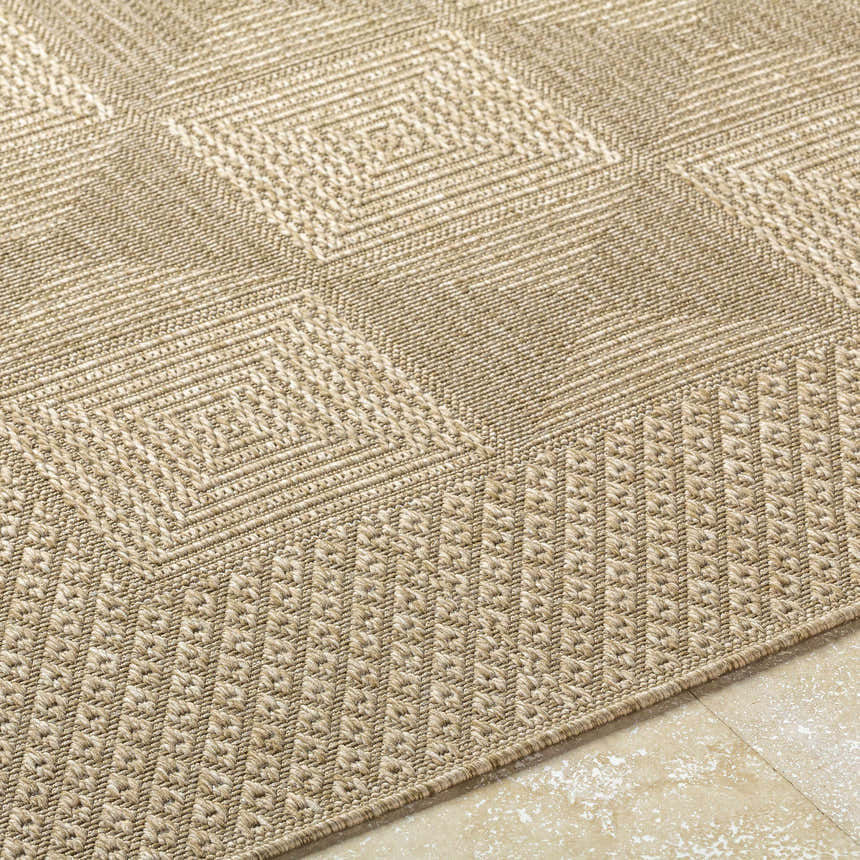 Close-up of the Anabia Brown Area Rug, showcasing its geometric diamond pattern and textured weave in prairie dust and tan. Texture