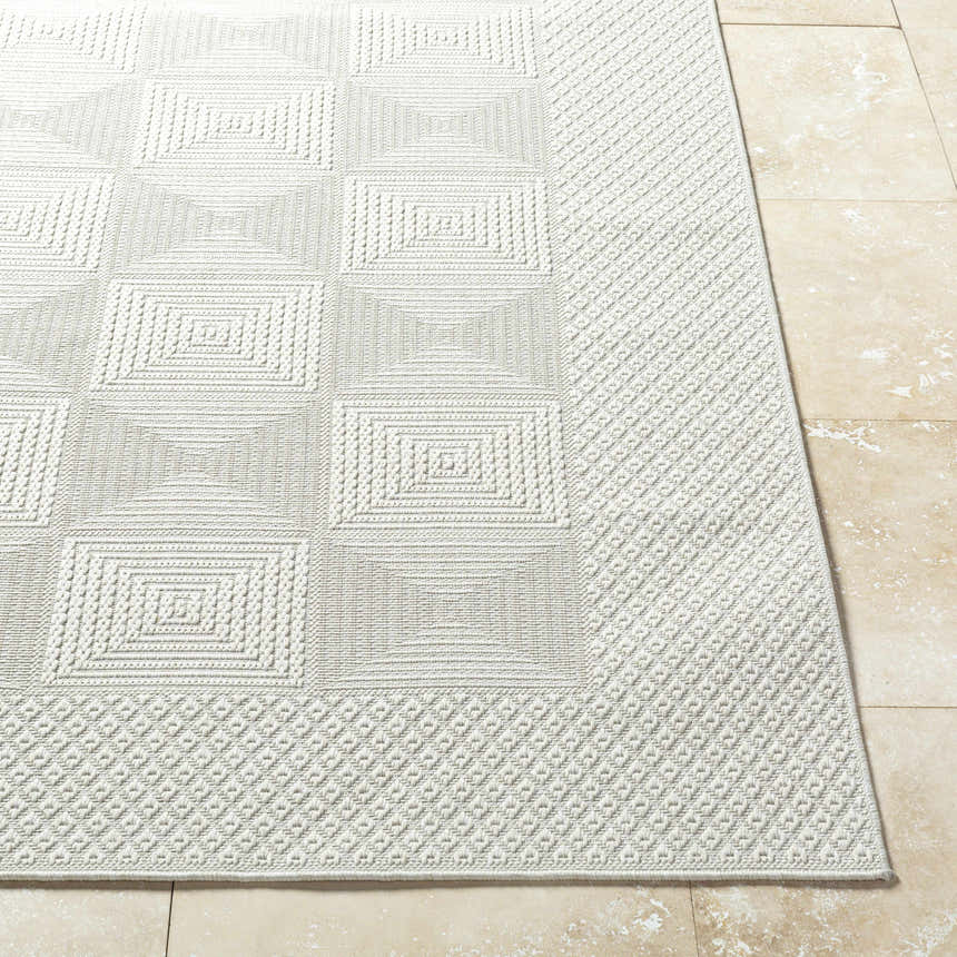 Close-up of the Anabia White Area Rug showing its geometric square pattern and textured, machine-woven construction. Front